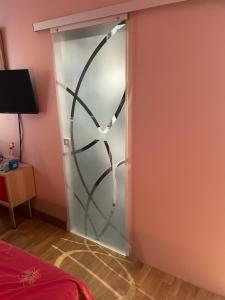 a sliding glass door with a spiral design on it at Chambre_privée_Collioure_centre in Collioure