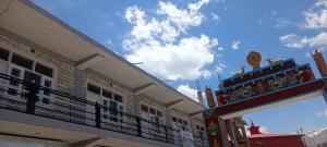 a building with a balcony on the side of it at nako valley home stay in Nako