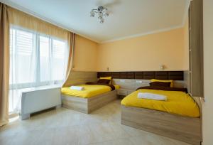 a bedroom with two beds and a tv in it at Luxury Sea Villa - Kabalan 1 in Burgas City
