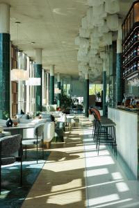 a lobby of a hotel with chairs and tables at Mercure Tallinn in Tallinn