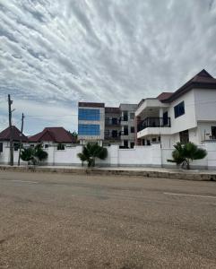 a building on the side of a street with a building at BAFFOUR APARTMENTS in Adiebaba