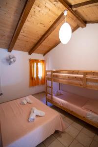 a bedroom with two bunk beds in a house at Villaggio Camping Esca in Marina di Camerota