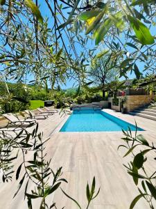 a swimming pool in the middle of a yard at Le petit Chacel in Sourcieux-les-Mines