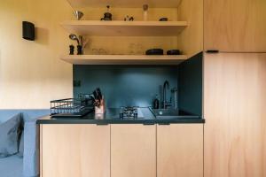 a kitchen with a black counter and a sink at cozy Black Forest Tiny House close to lake in Schluchsee