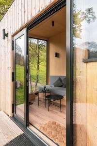 a glass extension to a house with a living room at cozy Black Forest Tiny House close to lake in Schluchsee