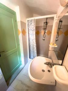 a bathroom with a toilet and a green door at Villaggio Camping Esca in Marina di Camerota +76 photos