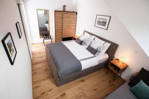 a bedroom with a large bed with a wooden floor at Apartma 21 - Ajda in Bovec