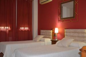Postel nebo postele na pokoji v ubytování Hostal Mont Royal