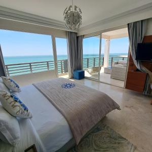 a bedroom with a bed with a view of the ocean at Hotel Buenavista Dakhla in Dakhla