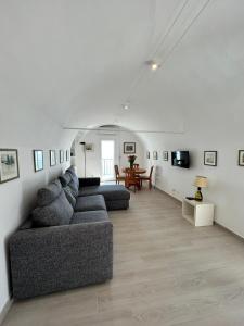 a living room with a couch and a table at Il mare tra gli olivi in Ventimiglia