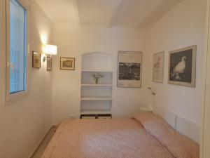 a small bedroom with a bed and a window at Il mare tra gli olivi in Ventimiglia +39 photos
