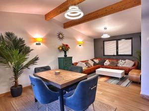a living room with a table and a couch at Chy Mena. South facing lodge with hot tub & views. in St. Agnes 