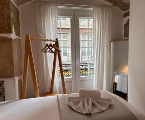 a bedroom with a bed and a large window at 262 Baixa Guesthouse in Lisbon