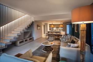 a living room with a couch and a table at Beachfront Luxury Villa & pool in Rivière Noire