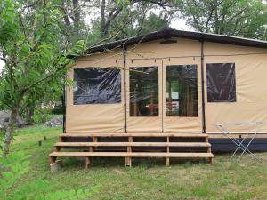 a small tent in a field with trees at Camping Onlycamp du Moulin in Clisson