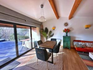 a living room with a wooden table and chairs at Chy Mena. South facing lodge with hot tub & views. in St. Agnes  +27 photos