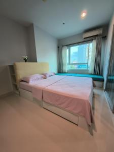 a bedroom with a large bed and a window at centric sea Pattaya in Pattaya Central