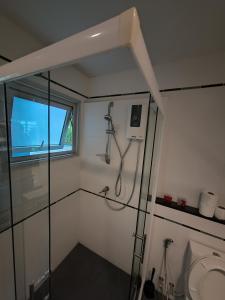 a bathroom with a shower and a window at centric sea Pattaya in Pattaya Central