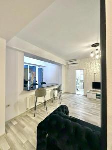 a living room with a couch and a table at SUMMERLAND Sea View Penthouse & Jacuzzi in Mamaia