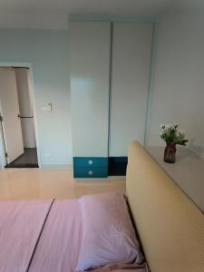 a bedroom with a bed and a dresser and a mirror at centric sea Pattaya in Pattaya Central
