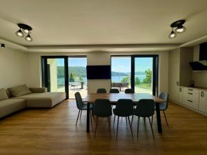a living room with a dining room table and chairs at Vila Valkov in Bžany
