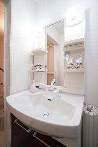 大阪市にある桜島パークサイドハウスBのバスルーム(白い洗面台、鏡付)