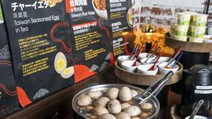 a table with a bowl of mushrooms and a menu at Just Sleep Osaka Shinsaibashi in Osaka
