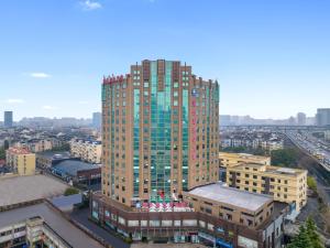 Un palazzo alto in una città con di Hangzhou Haiwaihai Communication Hotel a Hangzhou