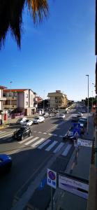 a busy city street with cars parked on the road at SunDays House #casa al mare in Quartu SantʼElena +16 photos