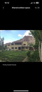 a picture of a building with a mountain in the background at Trinity Home Stay in Leh +38 photos