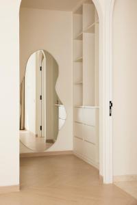 a room with a hallway with a circular mirror at Casa Lily - Luxury 3 Bedroom Villa in Bingin in Uluwatu +29 photos