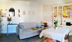 a living room with a couch and a table at SunDays House #casa al mare in Quartu SantʼElena