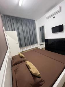 a living room with a couch and a flat screen tv at Gold apartament vlore free parking in Vlorë