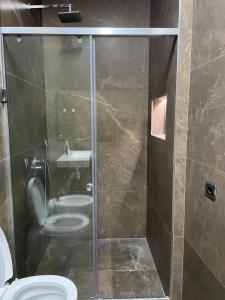 a bathroom with a shower with a toilet and a sink at Gold apartament vlore free parking in Vlorë +11 photos