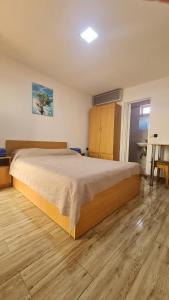 Hostel Maria في بيوش: غرفة نوم بسرير كبير وارضية خشبية
