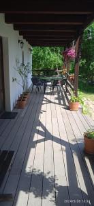 a wooden deck with picnic tables and potted plants at Agroturystyka Nad Czarnym in Giby
