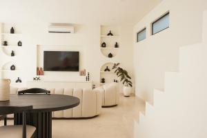 a living room with a couch and a table at Casa Lily - Luxury 3 Bedroom Villa in Bingin in Uluwatu