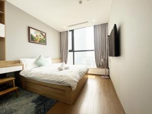 a bedroom with a bed and a large window at Luxury Apartment Vinhomes Skylake in Hanoi +148 photos