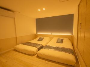 Postel nebo postele na pokoji v ubytování ひだまりinn