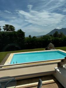 a large swimming pool with a view of a mountain at Holiday Village - Swimming pool apartments in Kamena Vourla