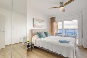 a white bedroom with a bed and a window at Monaco 1A Puerto Roses - Barneda in Roses