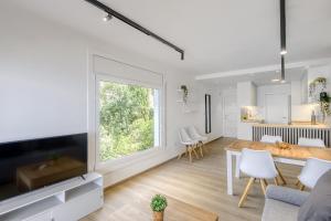 a living room and dining room with a large window at Monaco 1A Puerto Roses - Barneda in Roses