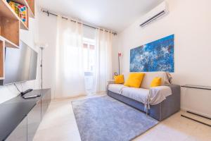 a living room with a couch and a tv at Lungotevere Apartment in Rome