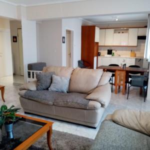 a living room with a couch and a kitchen at Apartment by the beach with amazing sea view in Perea