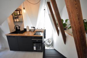 a kitchen with a counter and a sink in a room at Apartamenty Basztowa in Świdnica