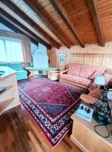 a living room with a couch and a rug at San vito di Cadore centro - Cortina D'ampezzo in San Vito di Cadore
