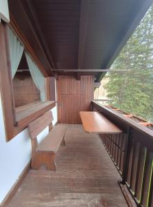a porch with two benches in a train car at San vito di Cadore centro - Cortina D'ampezzo in San Vito di Cadore +8 photos