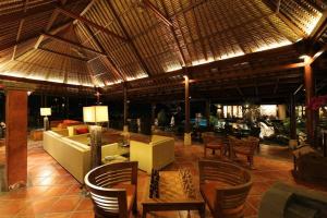 a resort lobby with chairs and a couch and tables at PURI BALI STANIA, Cisarua West Java in Cilama