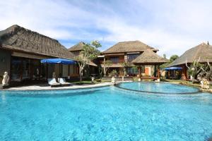 a large swimming pool in front of a house at PURI BALI STANIA, Cisarua West Java in Cilama