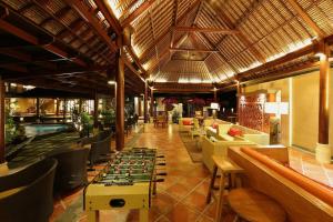 a restaurant with a pool and tables and chairs at PURI BALI STANIA, Cisarua West Java in Cilama